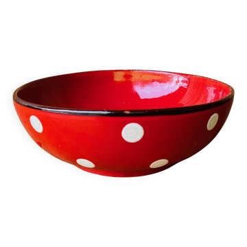 Ceramic salad bowl in red with white polka dots.