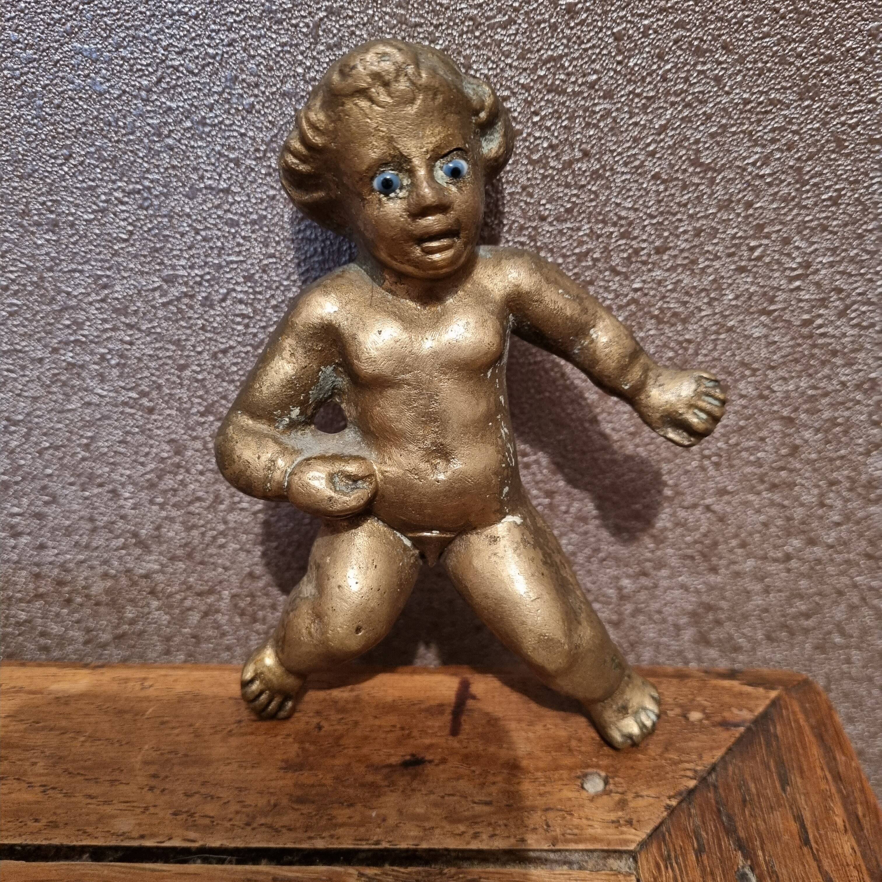 Rare bronze child statuette with blue eyes