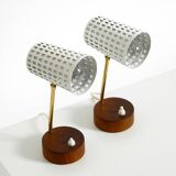 A pair of mid-century modern bedside lamps with perforated metal shades