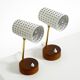 A pair of mid-century modern bedside lamps with perforated metal shades