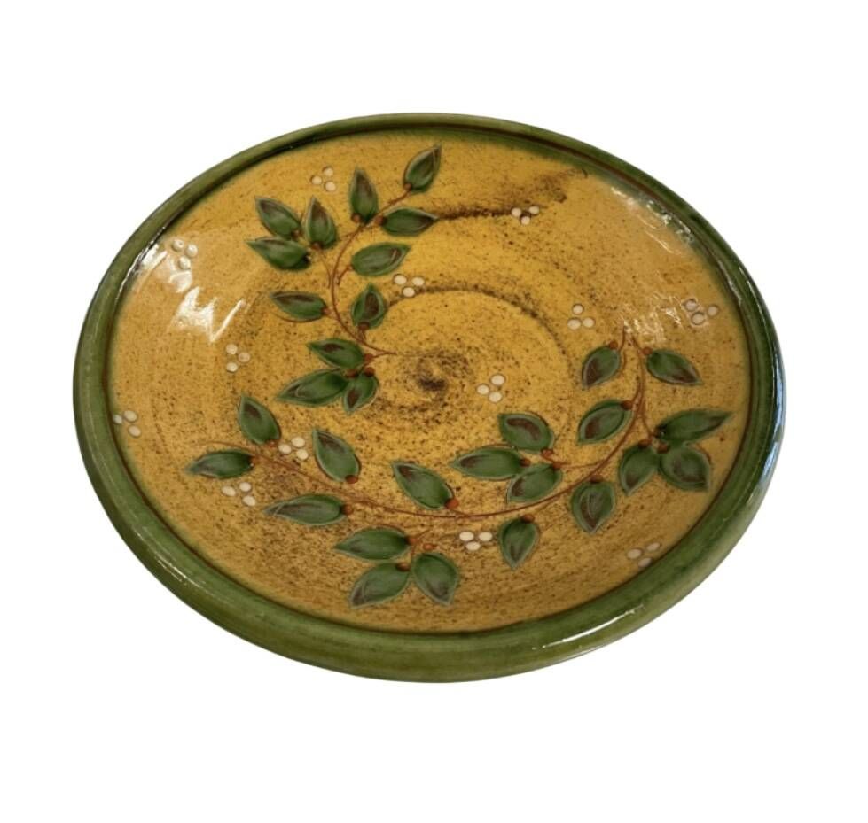 Decorative glazed terracotta plate with olive leaf pattern.