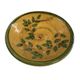 Decorative glazed terracotta plate with olive leaf pattern.
