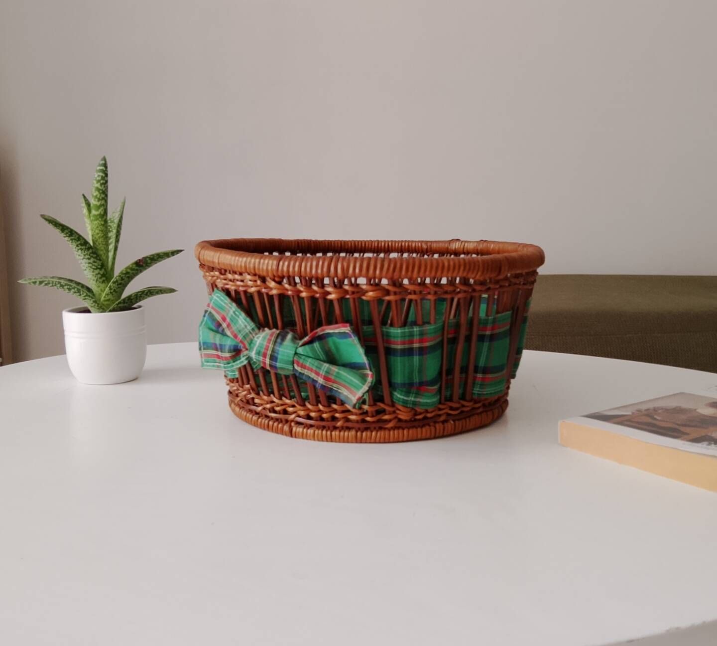 Vintage wicker and rattan basket with tartan fabric.
