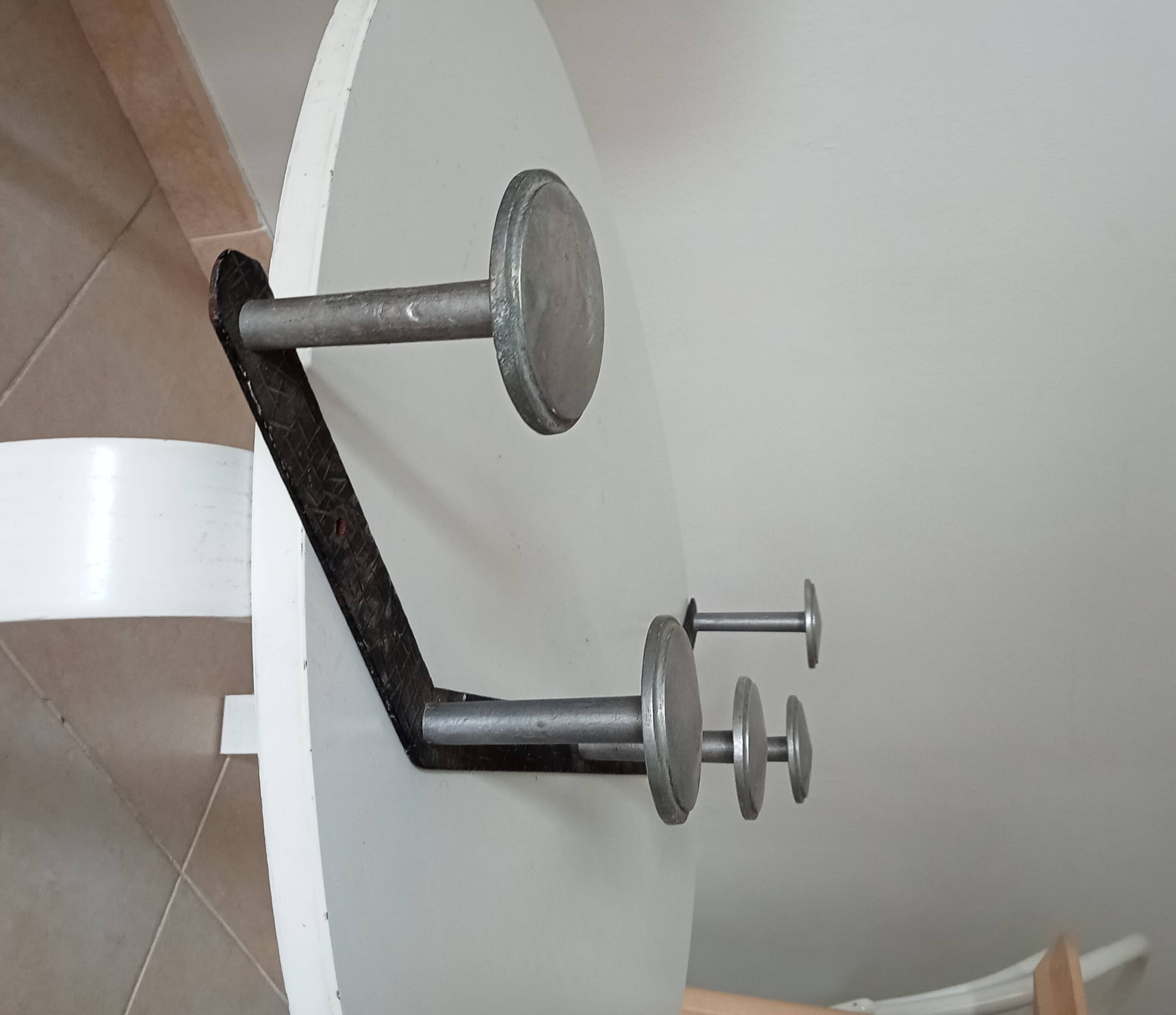 Vintage 1950s wall coat rack, wrought iron with chiselled details and solid aluminium.