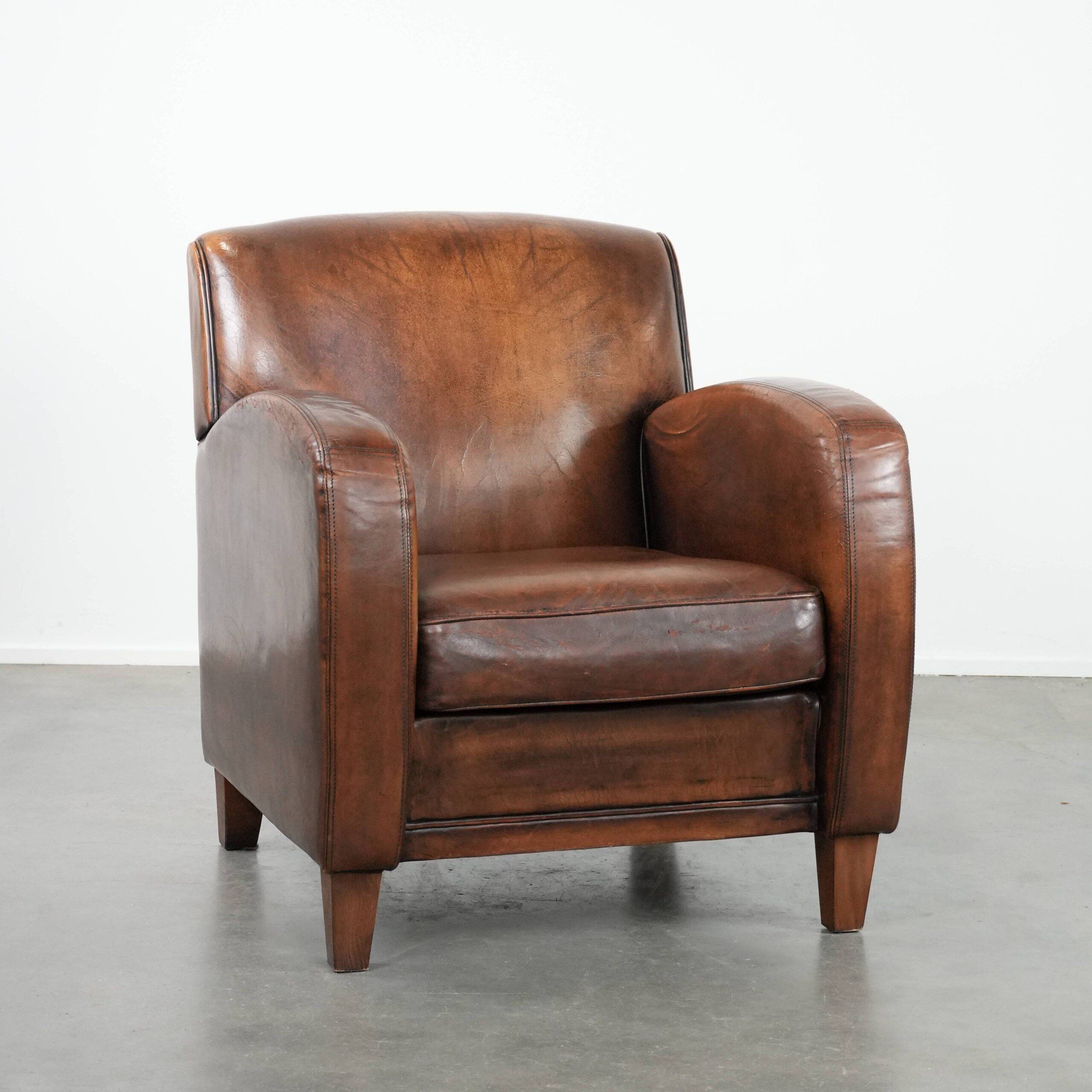 Characterful vintage sheepskin leather armchair with beautiful colours