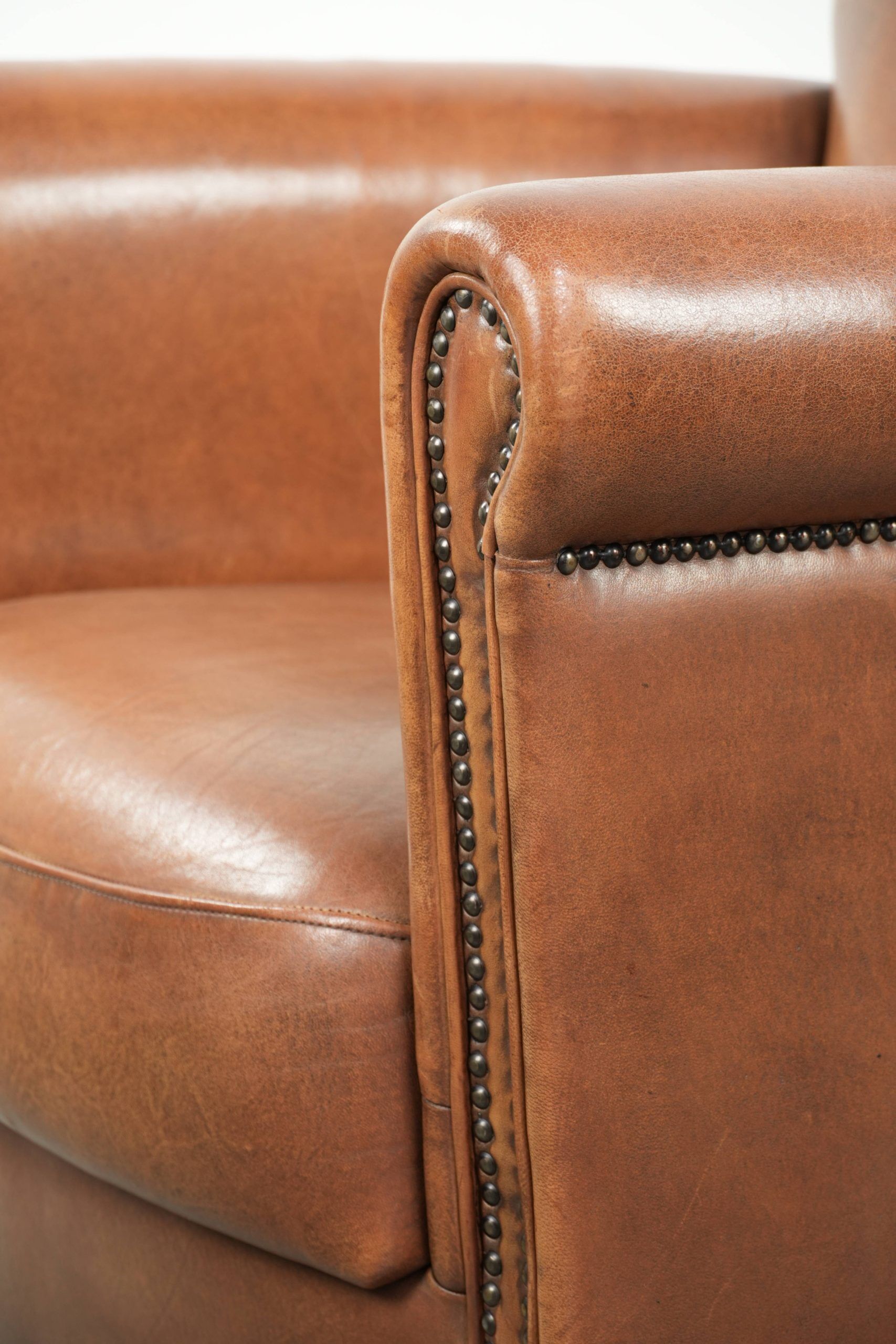 Armchair made of sheepskin leather with refined decorative nail finish