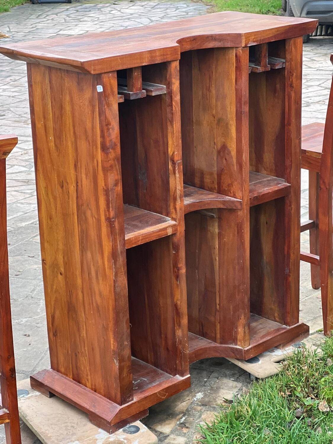Exotic wood bar with 2 high stools.