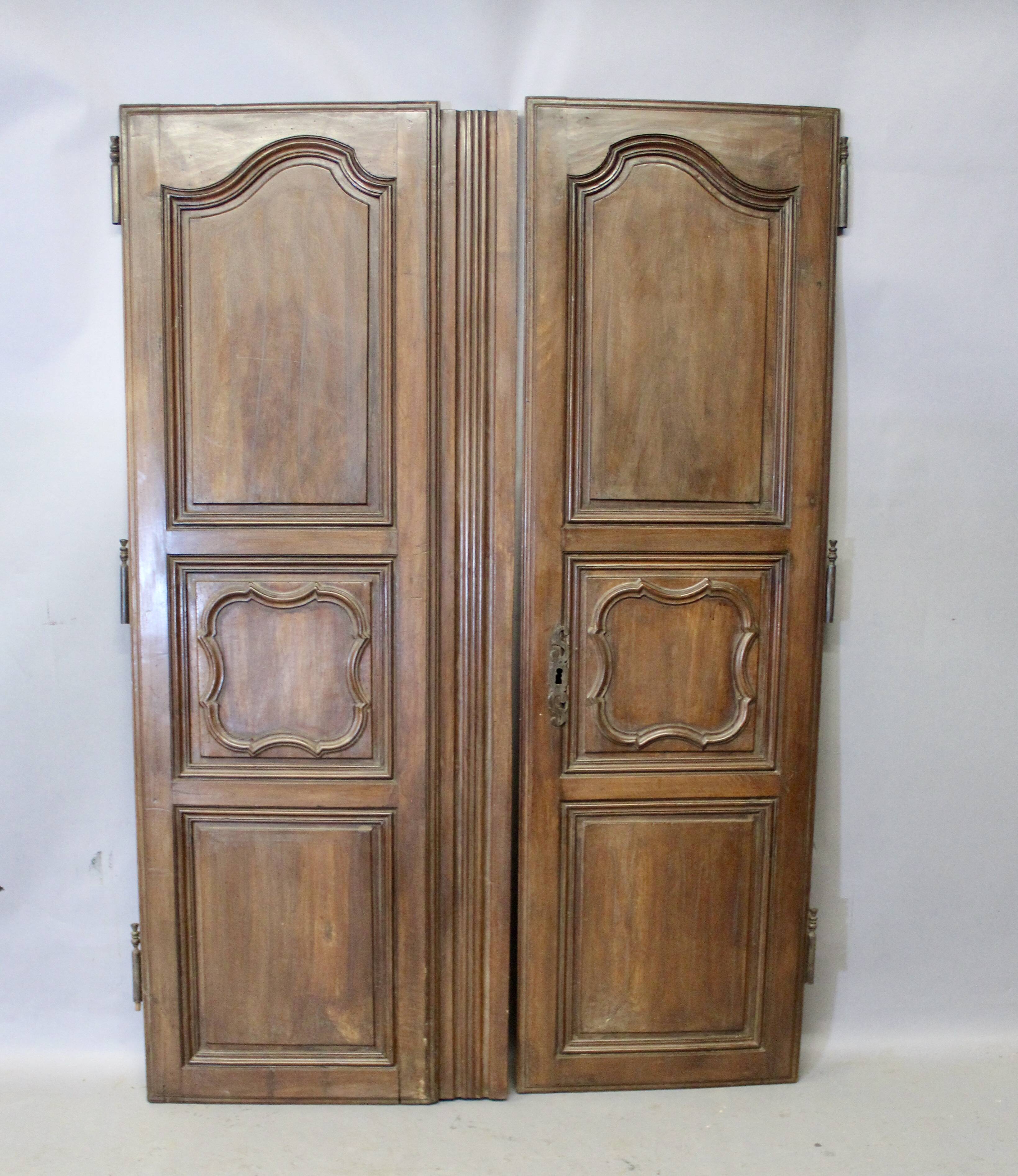 Pair of Louis XV walnut doors with medallion