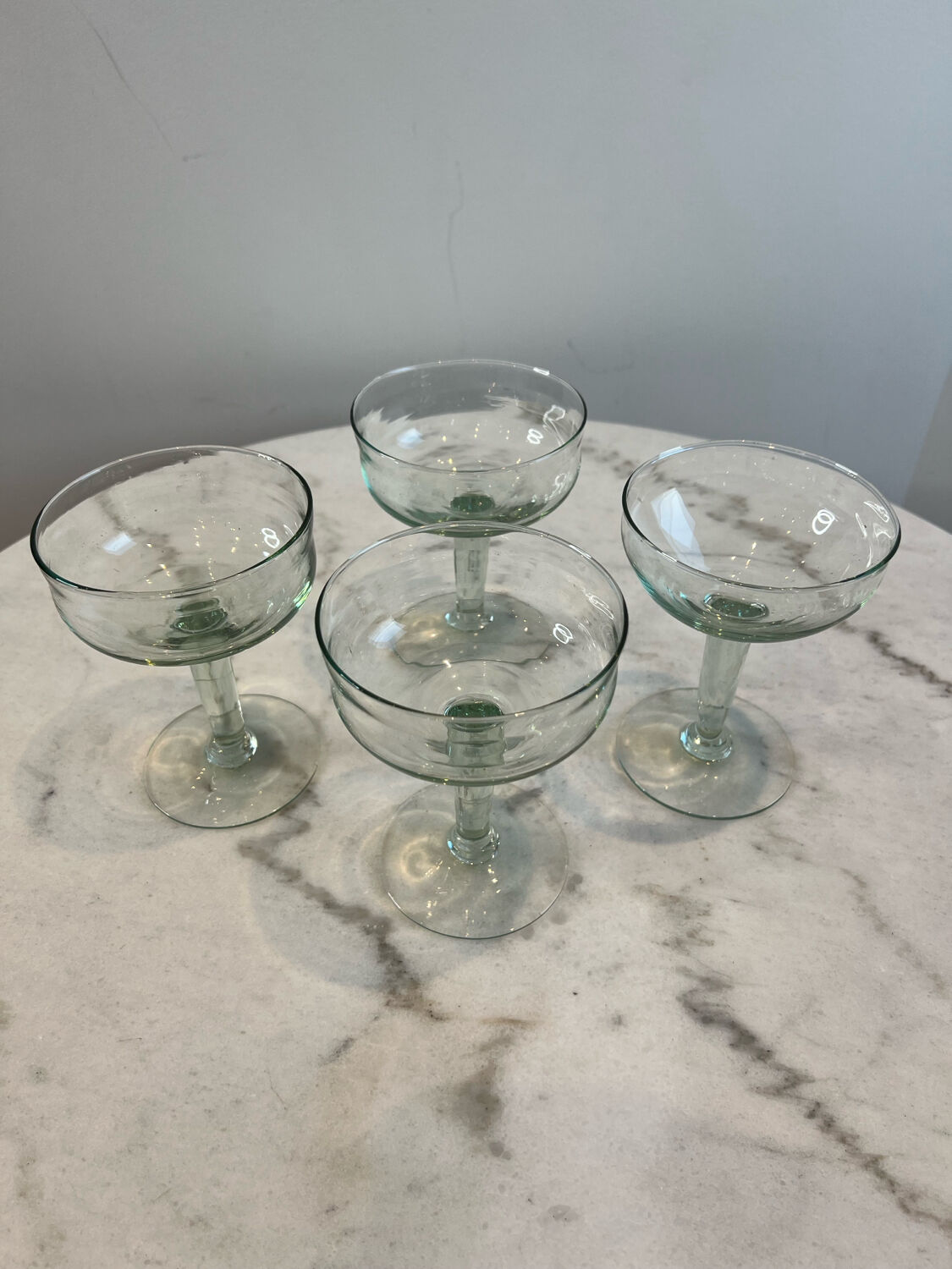 Set of four blown glass stemmed glasses.