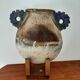 Oval/round pottery on base signed