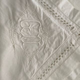 White cotton pillowcase with embroidery and monogram from the 1960s.