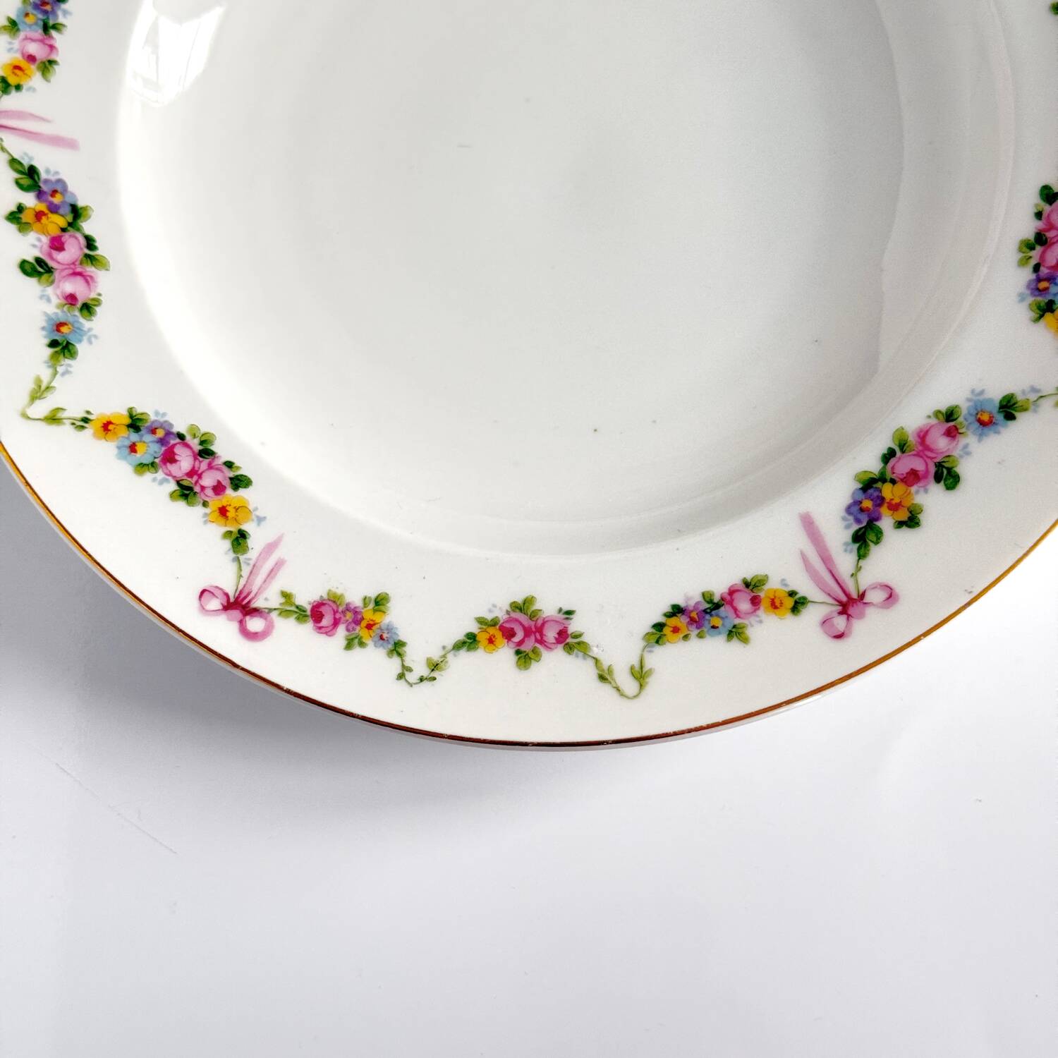 Pair of soup plates by EPIAG | ribbons/bows and garlands