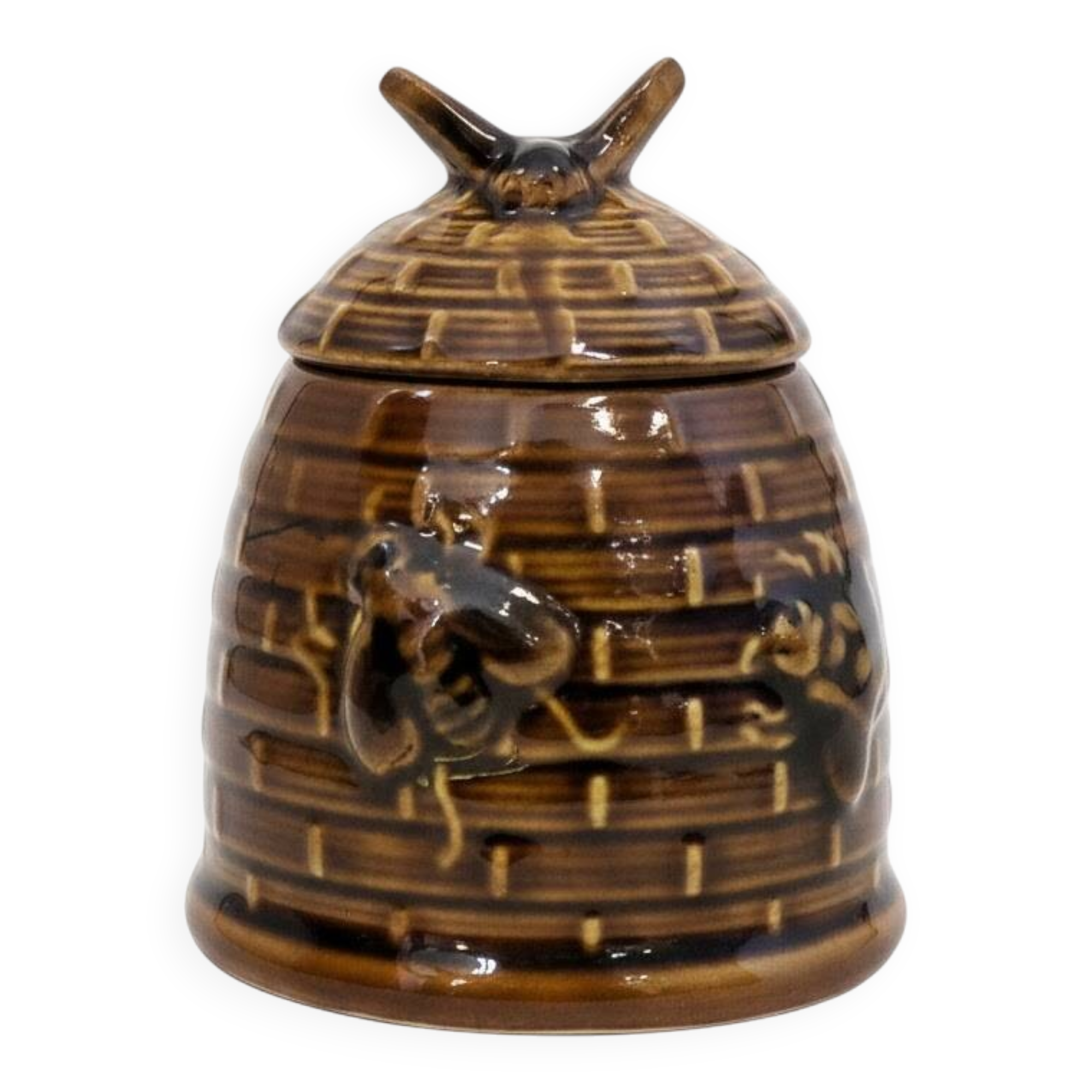 Honey pot in the shape of a hive decorated with bees.