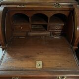 Antique solid wood secretary with a drop-down cylinder compartment.