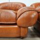 2 fauteuils en cuir cognac, années 1970