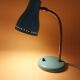 Green brass desk lamp with a goose neck on a ball joint from the 1960s.