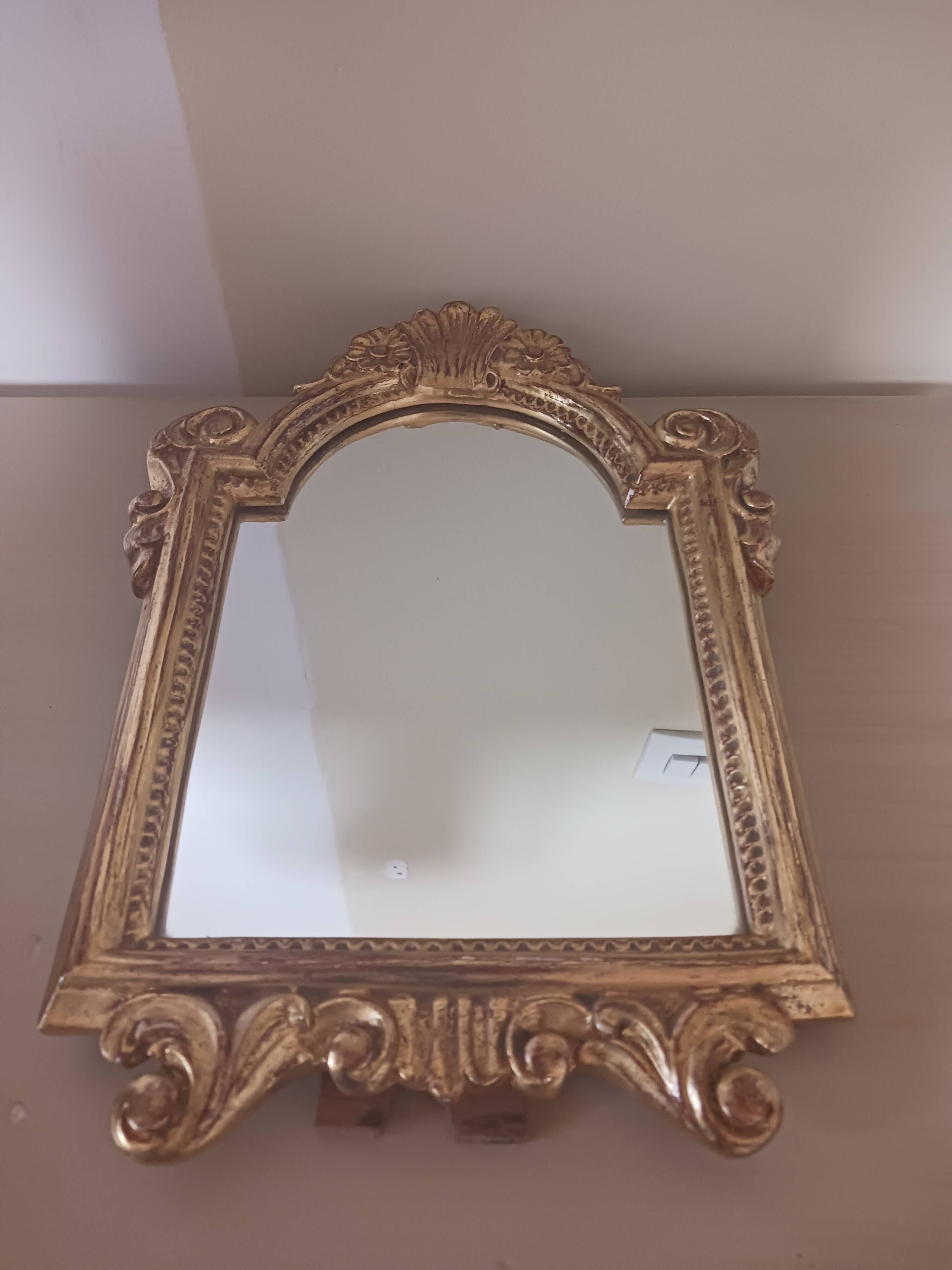 Antique mirror in gilded wood.