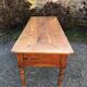 Antique cherry farmhouse table with turned legs and 2 drawers.