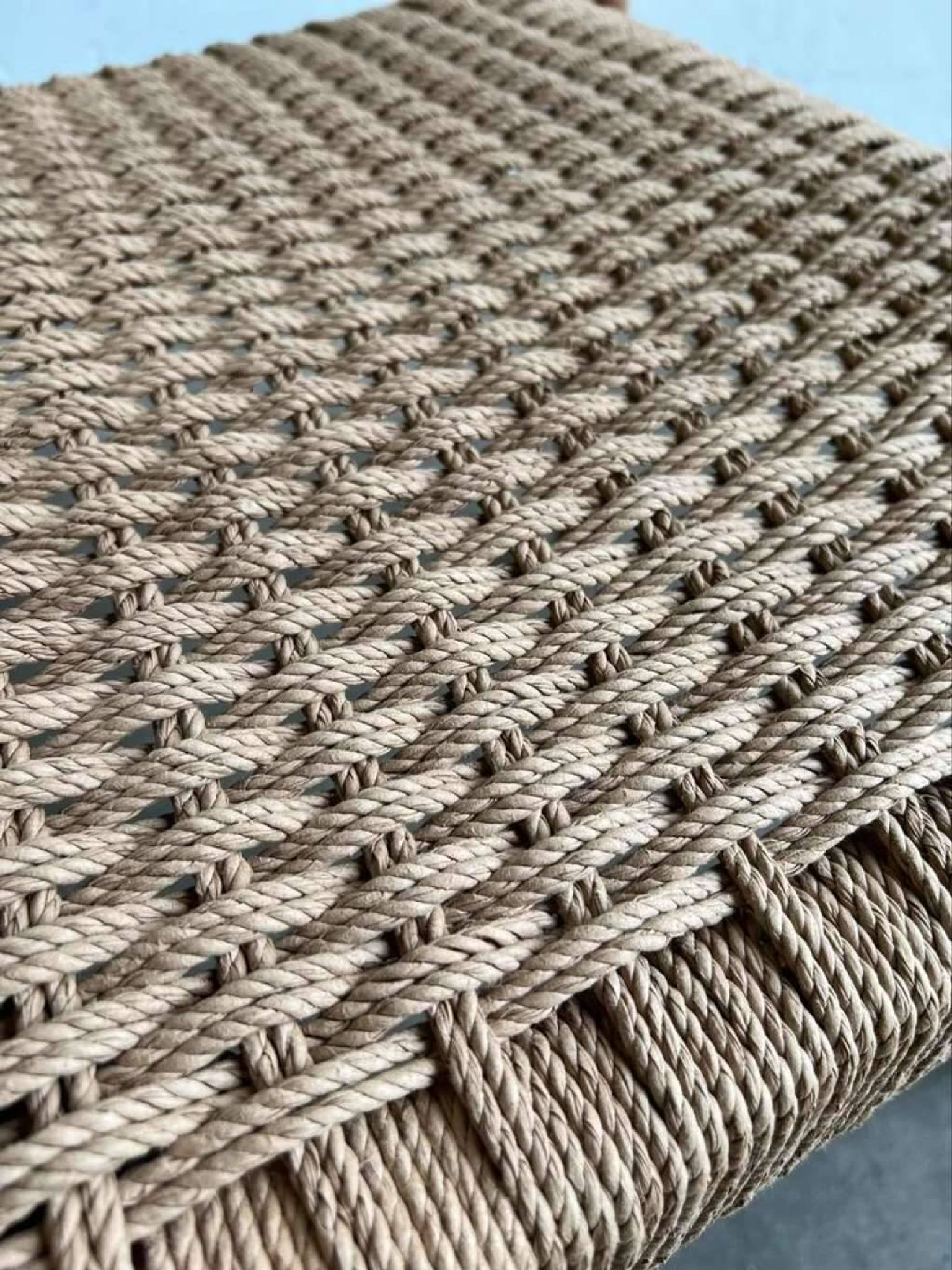 Solid wood chair with weaved seat and armrests