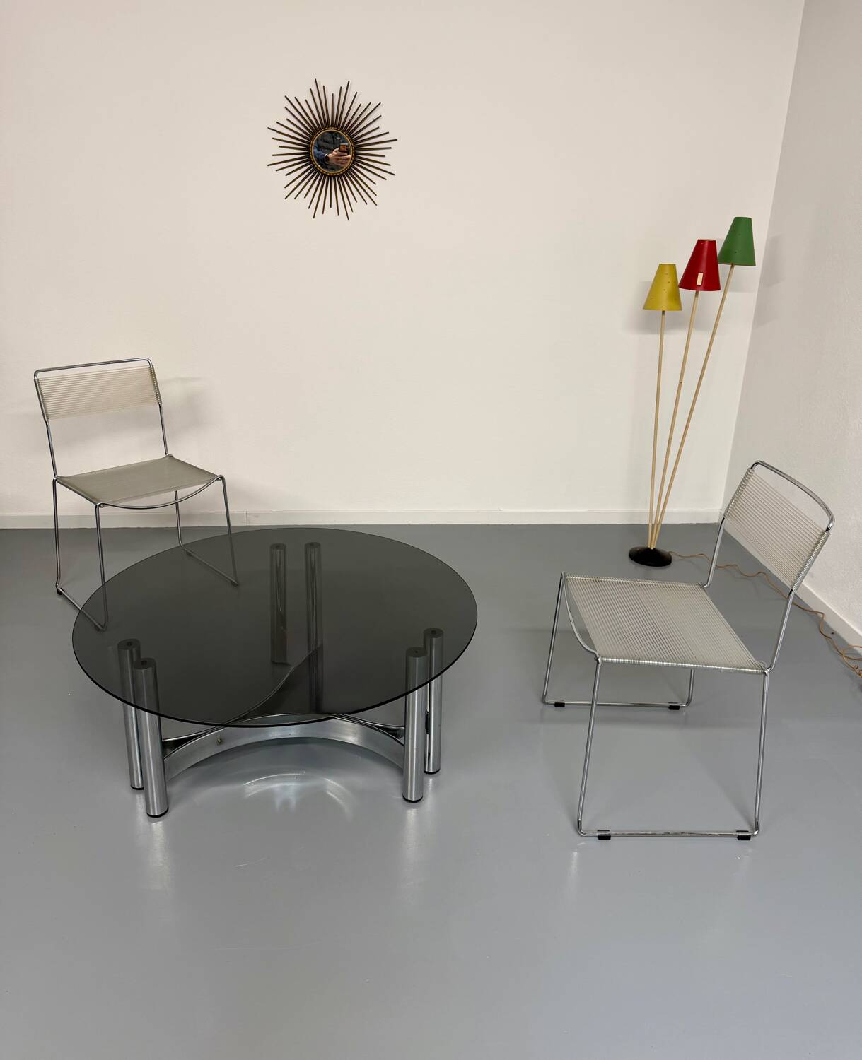 Round coffee table in smoked glass and chrome steel, 1970s design.