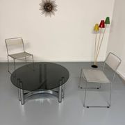 Round coffee table in smoked glass and chrome steel, 1970s design.