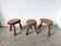 Set of three rustic solid wood tripod stools.