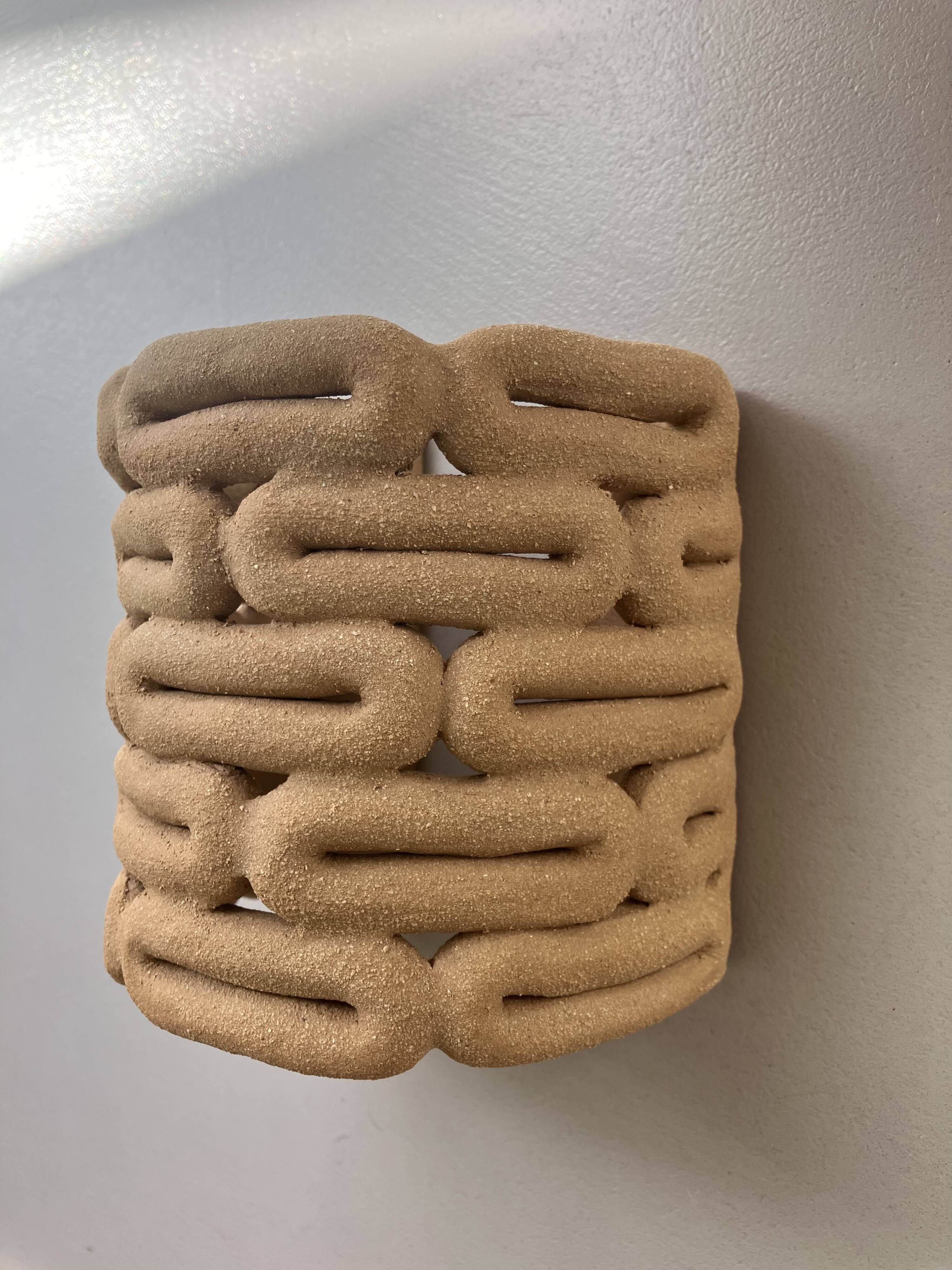 Handcrafted ceramic wall light in raw stoneware inspired by Mid Century design.