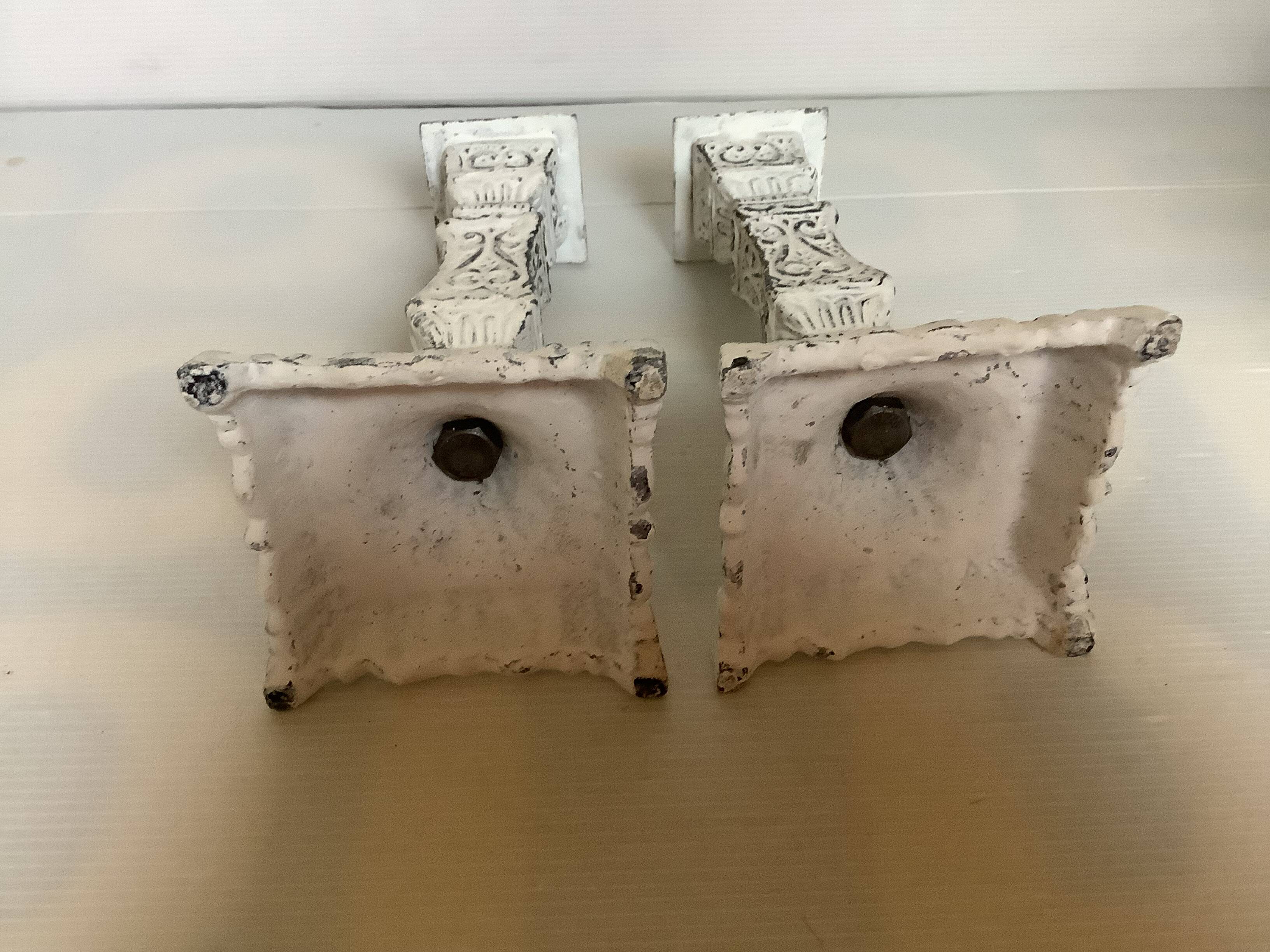 Pair of patinated cast iron candlesticks