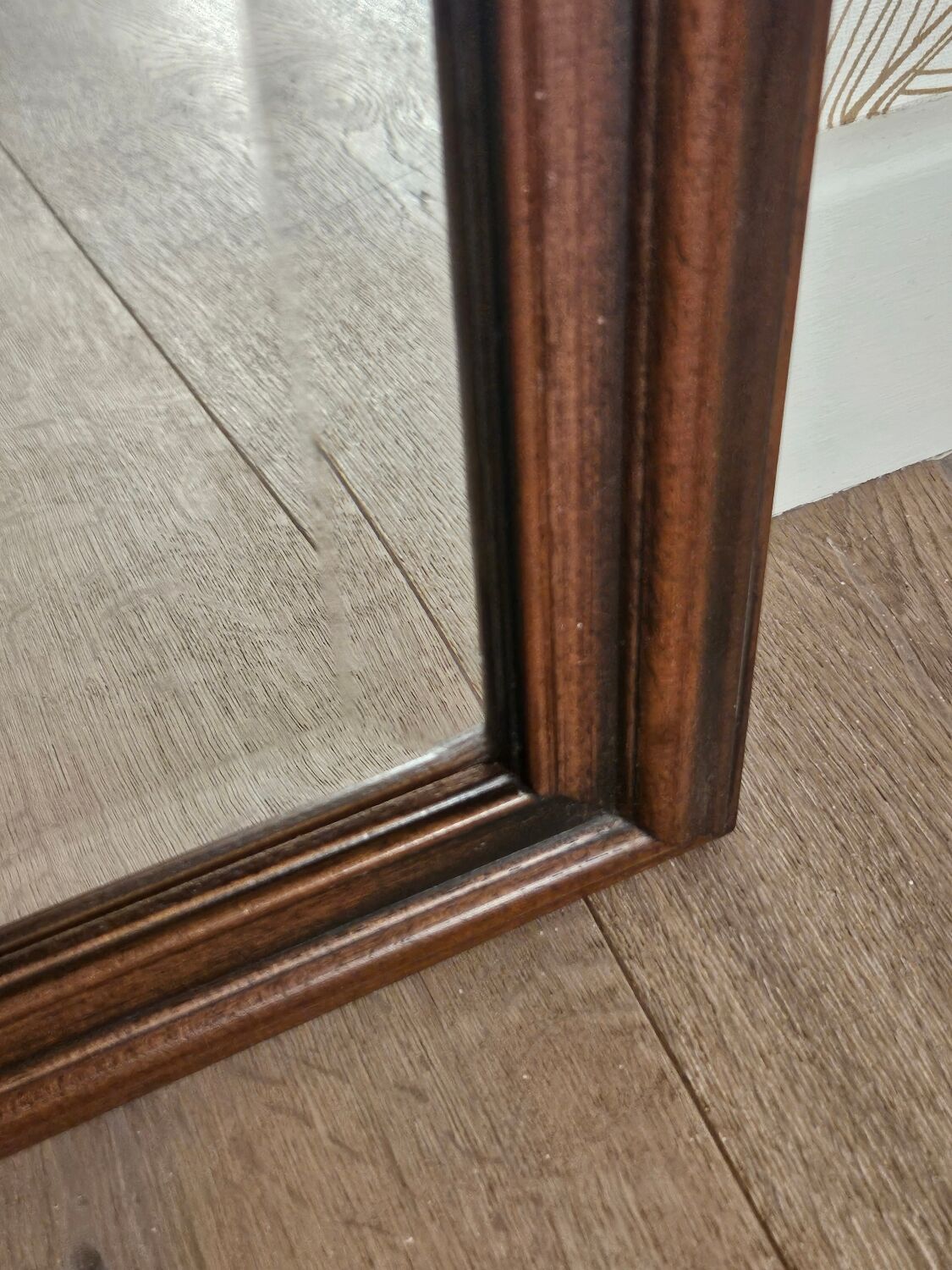 Beveled glass mirror in its wooden frame