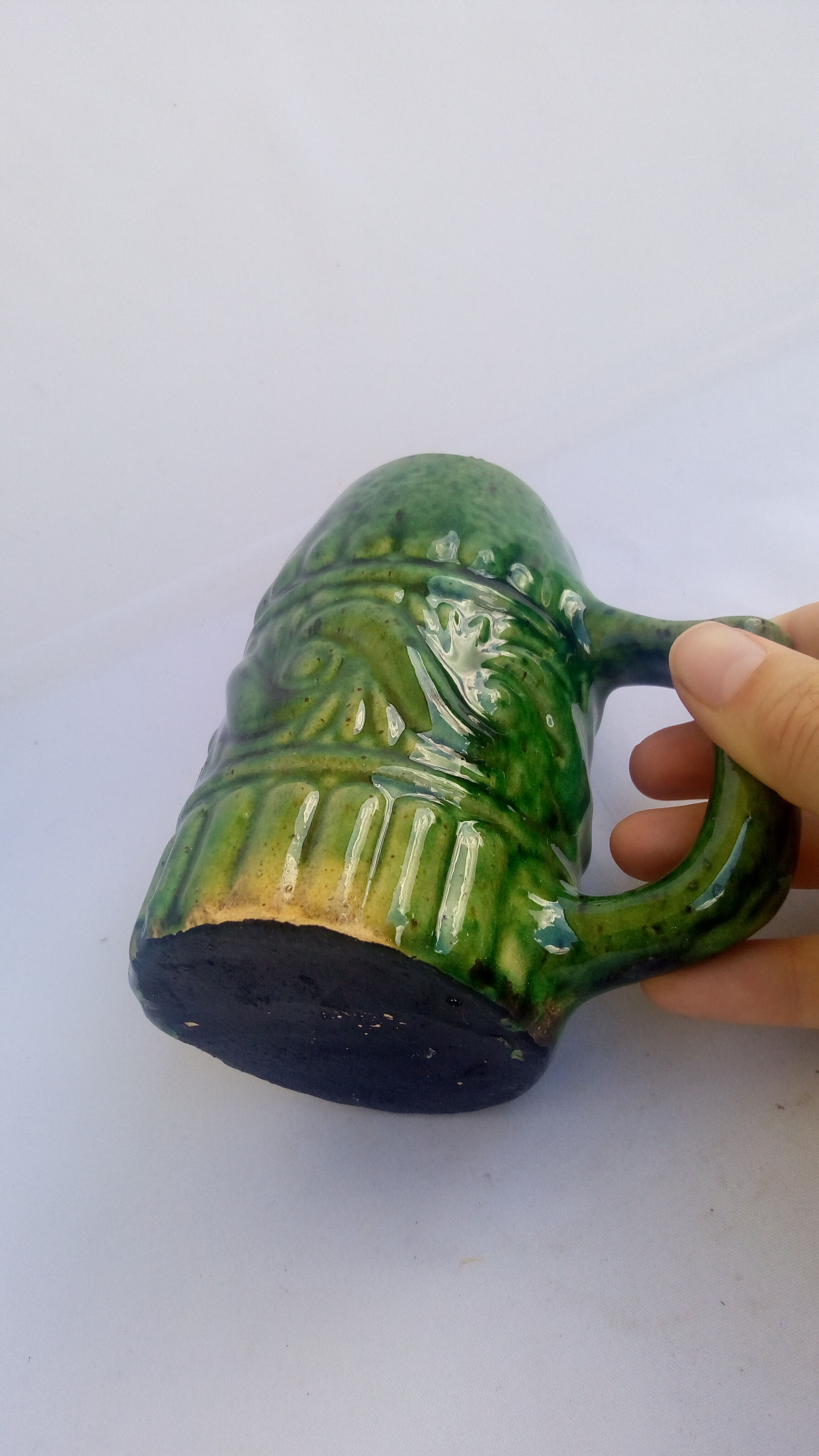 Green ceramic cup with decorations
