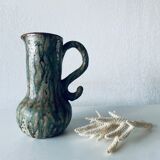 Old pitcher in glazed terracotta