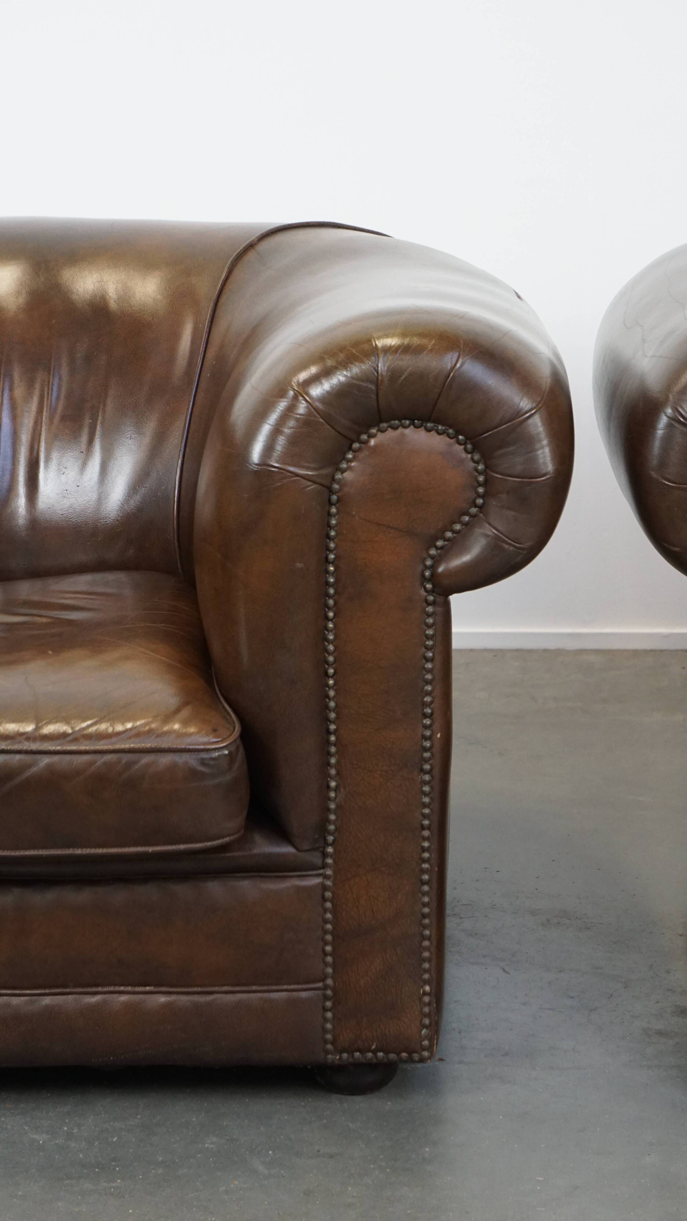 2 Chesterfield armchairs in dark brown cowhide