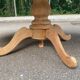 Round dining table with a central pedestal, extendable, stripped in solid walnut with 2 extensions.