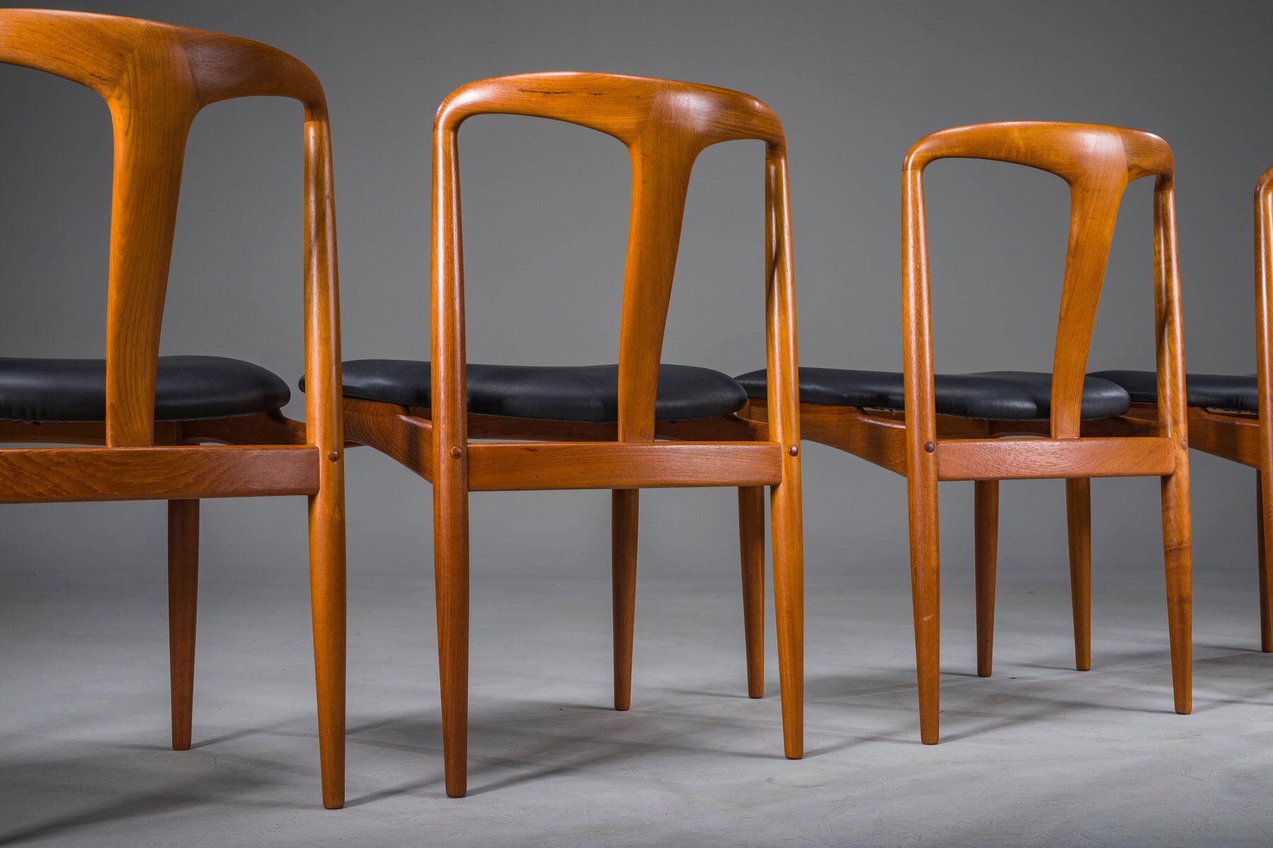 Juliane dining chairs in teak and black leather by Johannes Andersen for Uldum Møbelfabrik, Denmark, 1960s, set of 6