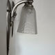 Silver Art Deco wall lights with frosted glass.