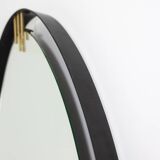 Lacquered and patinated brass mirror, ovoid shape. 1950s/60s.