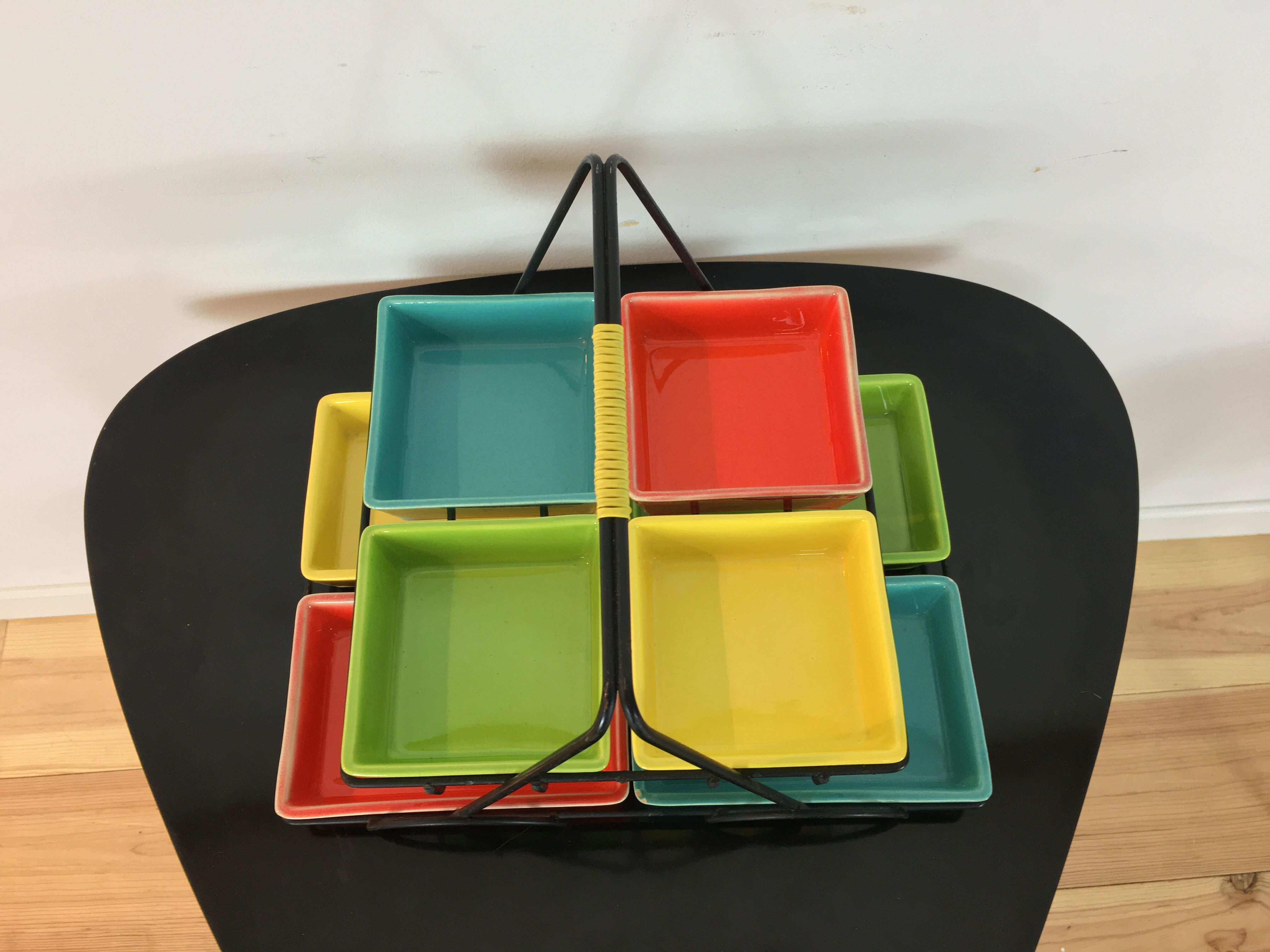 Black metal appetizer set with colorful ceramic ramekins