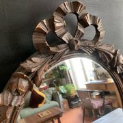 Antique oval mirror in carved wood and Louis XVI style knot