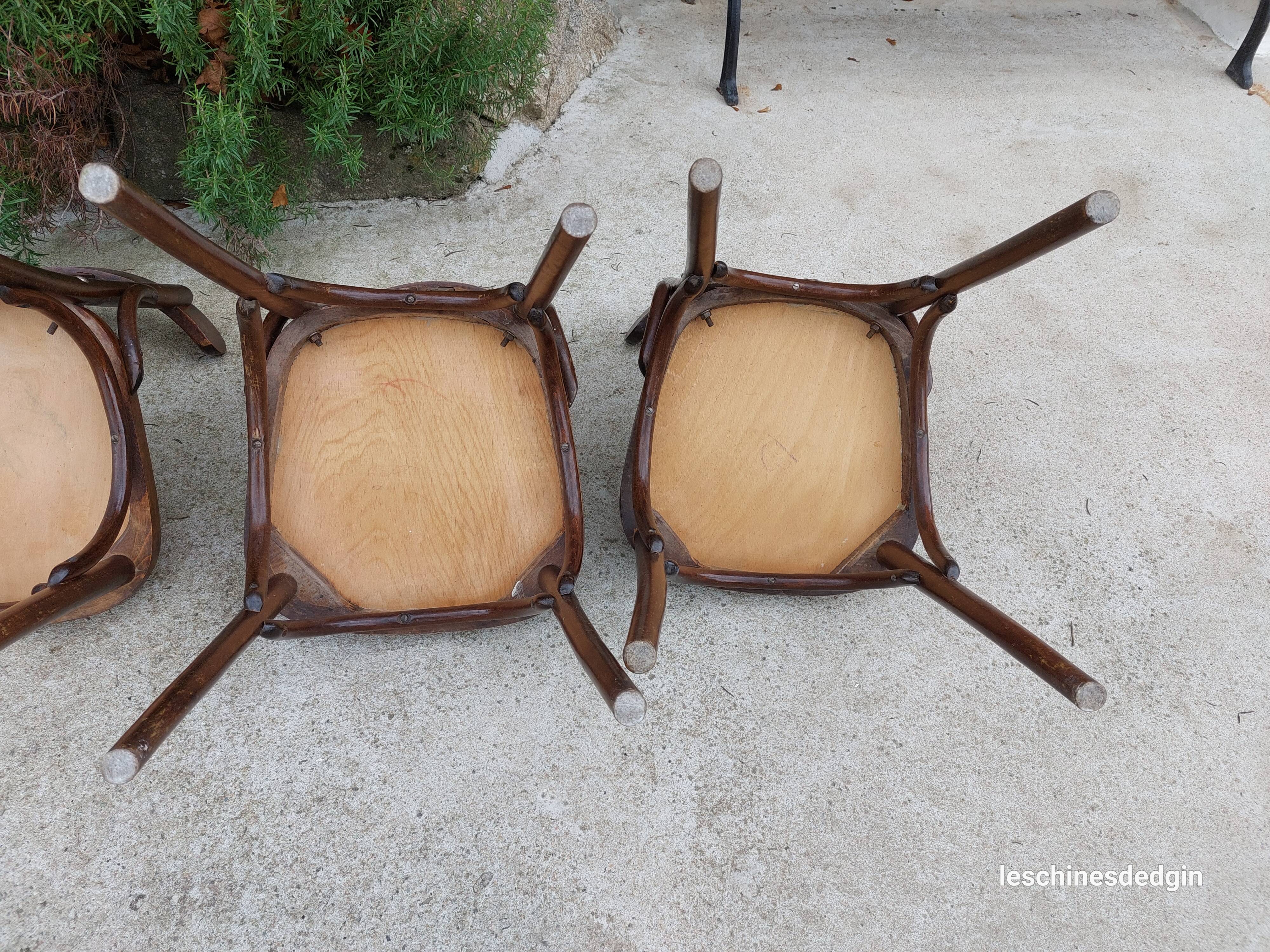 4 bentwood bistro chairs with a pattern on the seat