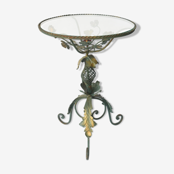 Wrought iron pedestal table decorated with flowers and foliage