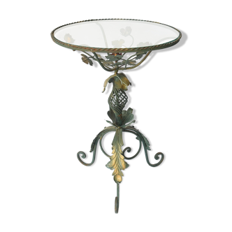 Wrought iron pedestal table decorated with flowers and foliage