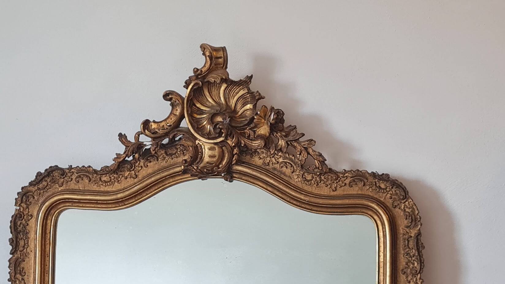 Antique Louis Philippe mirror with a pediment.