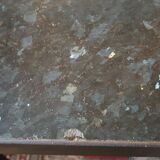 Coffee table with top in silver granite and welded steel base.