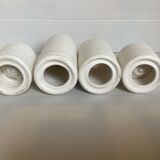 Four white earthenware candle holders