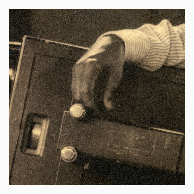 Photograph of an Indian director leaning on his camera