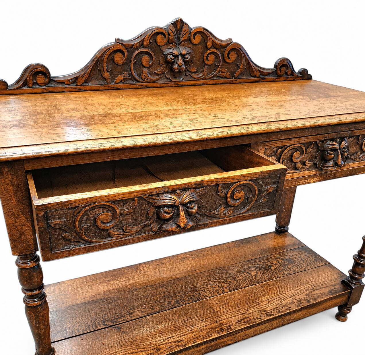Victorian Gothic Oak side table, decorative carved round 1920. Green Mask decoration
