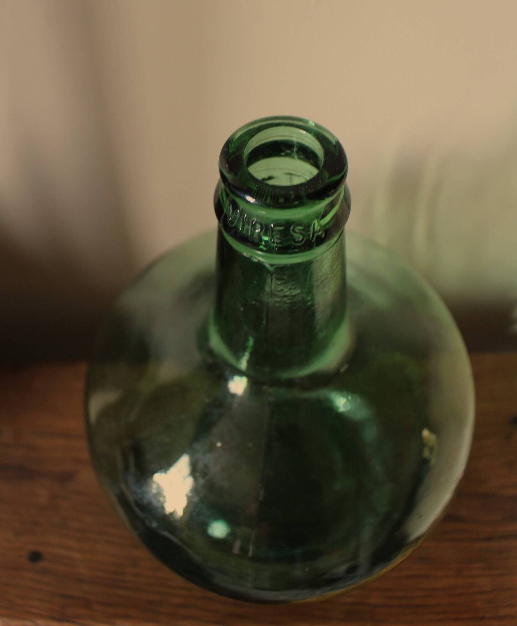 Dame Jeanne carboy from the Viresa collection in dark green glass