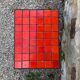 Orange tiled pedestal table