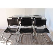 Series of 6 minimalist chairs in chrome metal and black leather around 1970