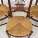 3 wooden and straw chairs, decorated with a sheaf of wheat.